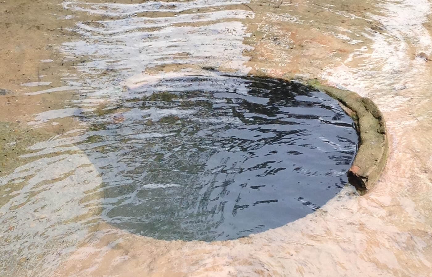 Water overflowing manhole cover